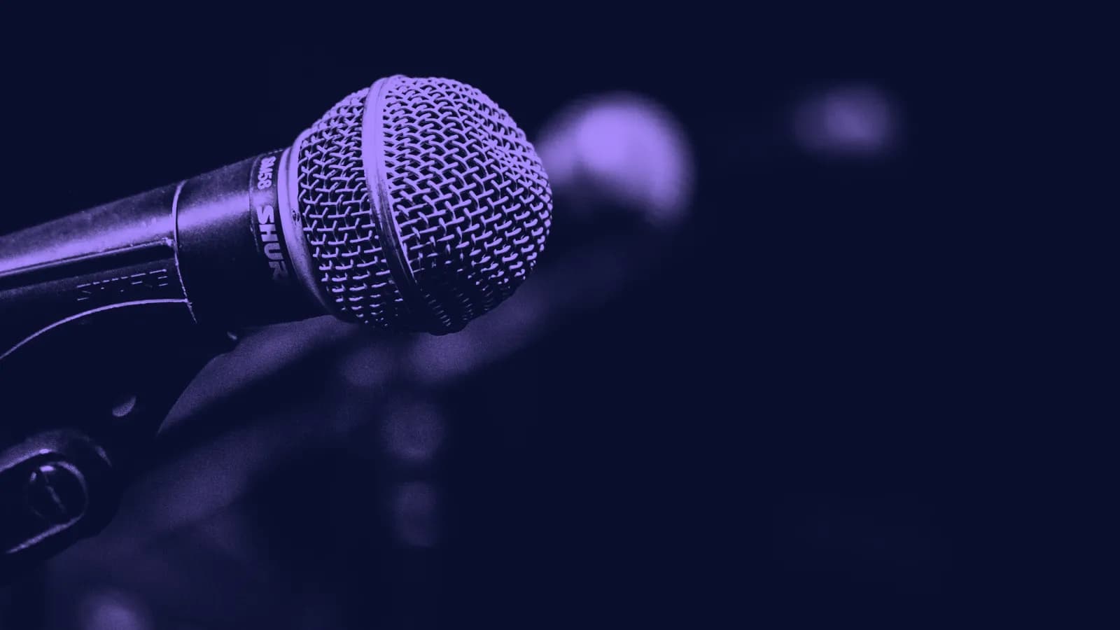 A close-up of a stage microphone